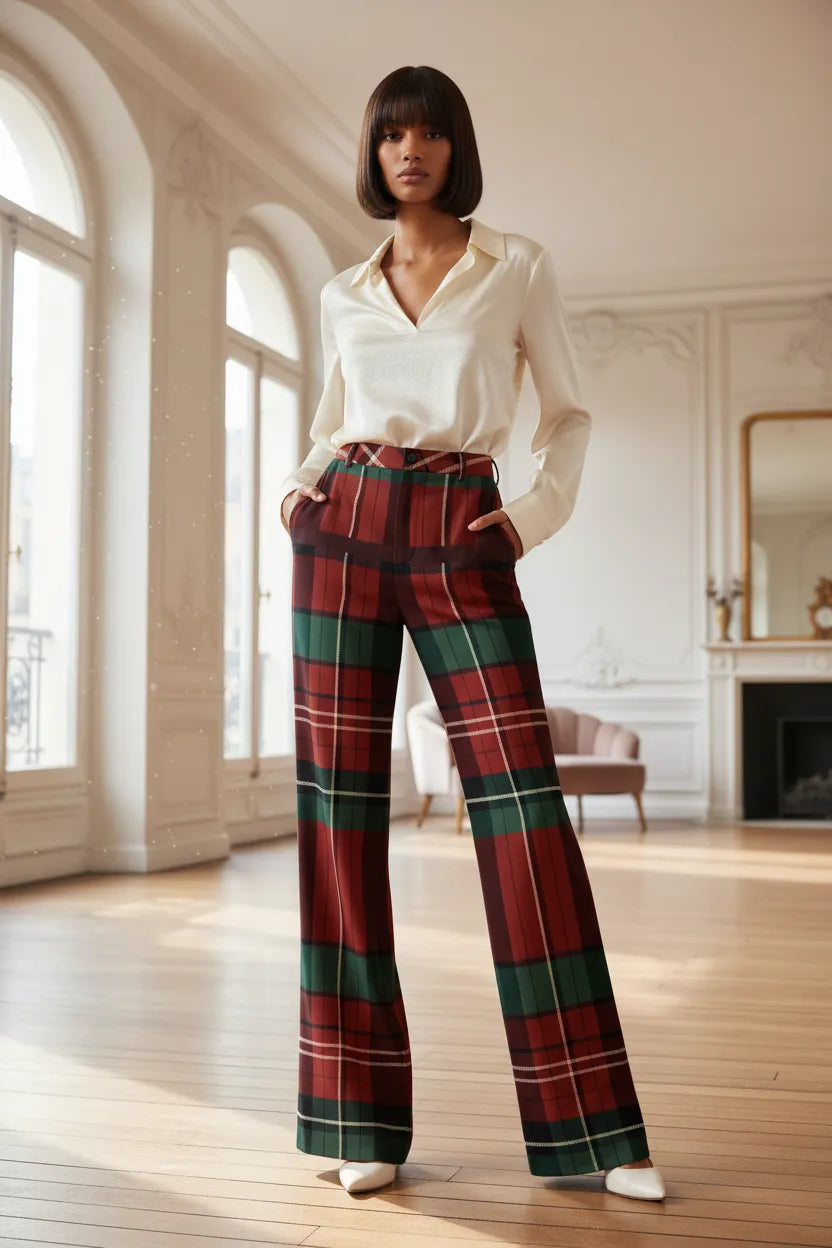 Woman wearing burgundy green tartan wide leg trousers with white blouse in spacious room