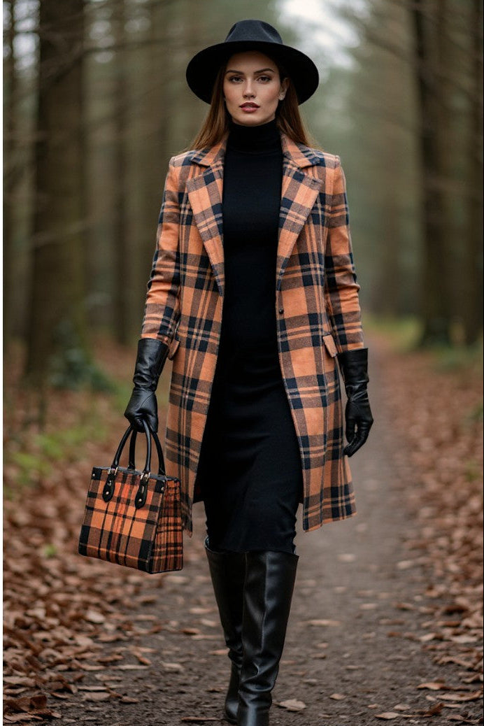 Woman carrying heritage inspired designer handbags by Angelic Blessings Shop wearing matching plaid coat and black hat