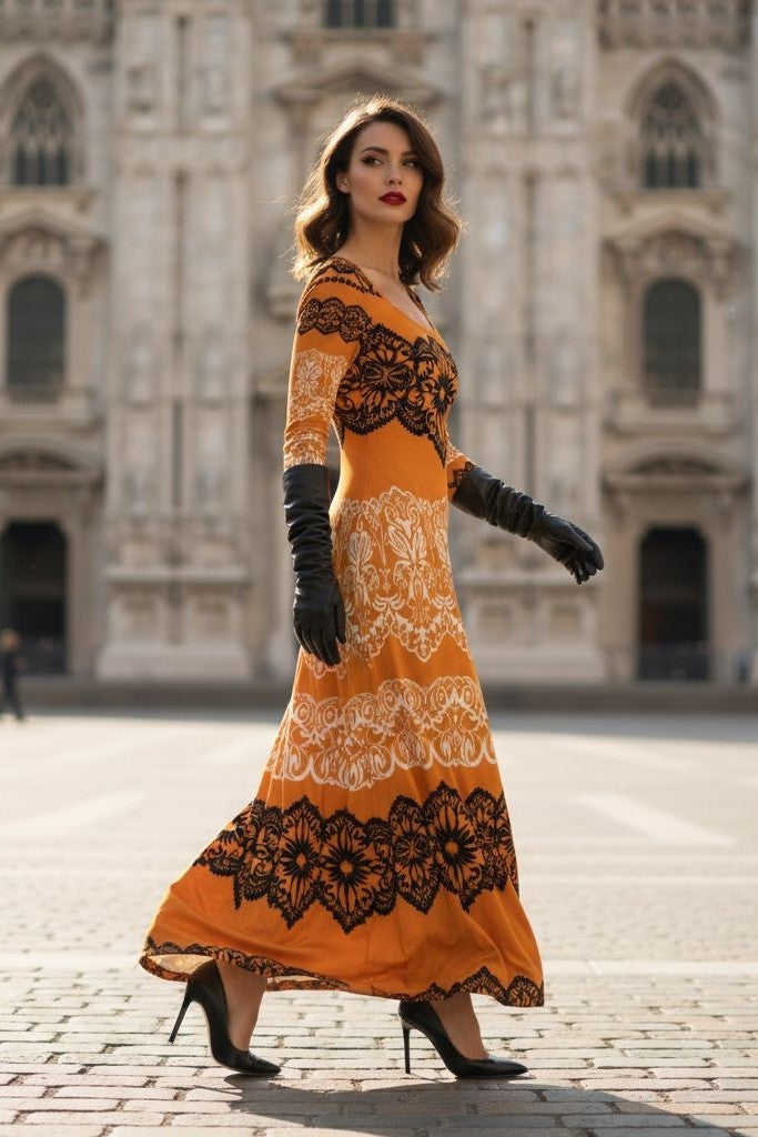 Luxury gold velvet evening gown with black lace details worn by model in black gloves and heels