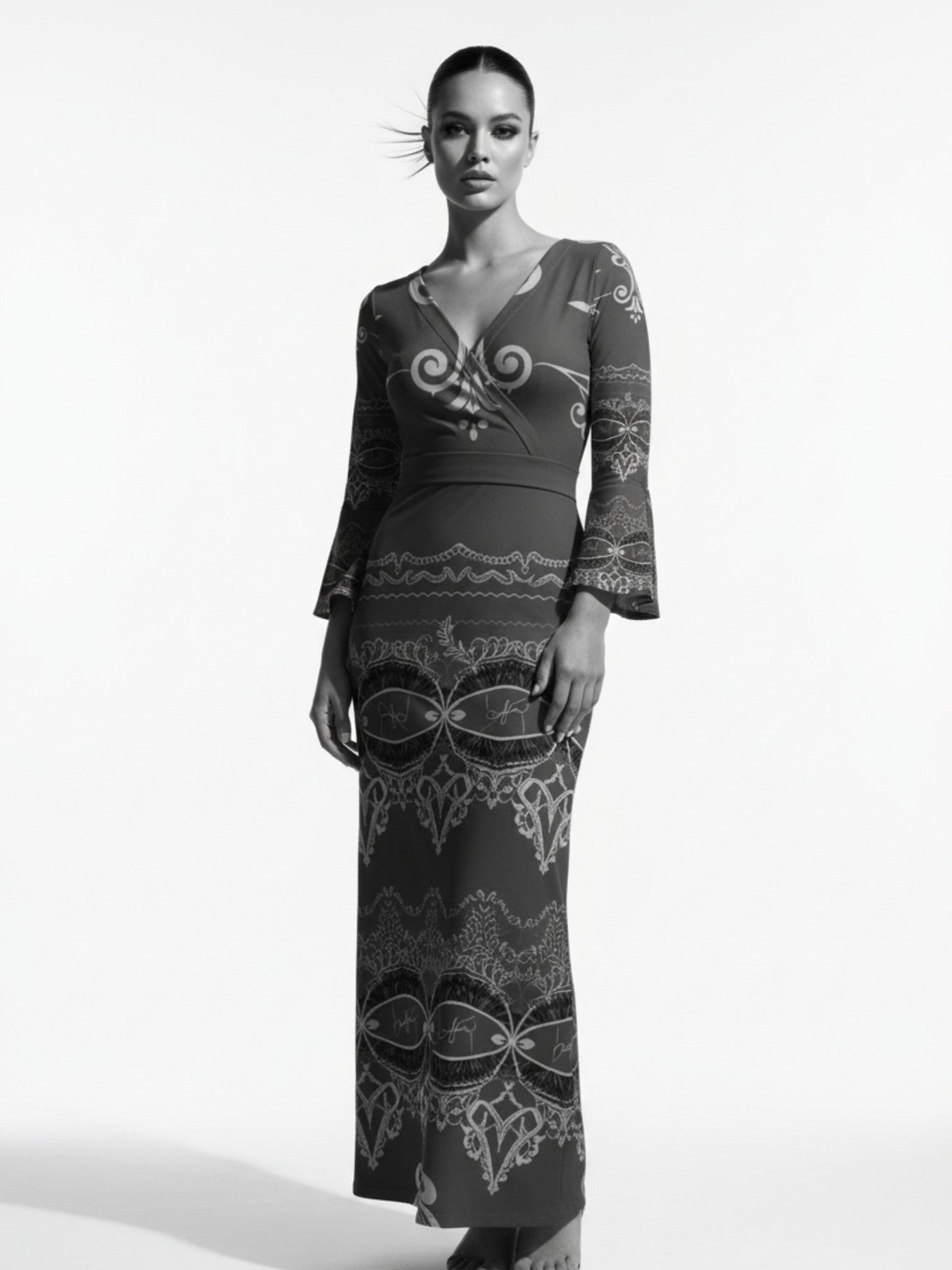 Woman wearing a long sleeve v-neck evening gown maxi dress with intricate patterns from Angelic Blessings Shop