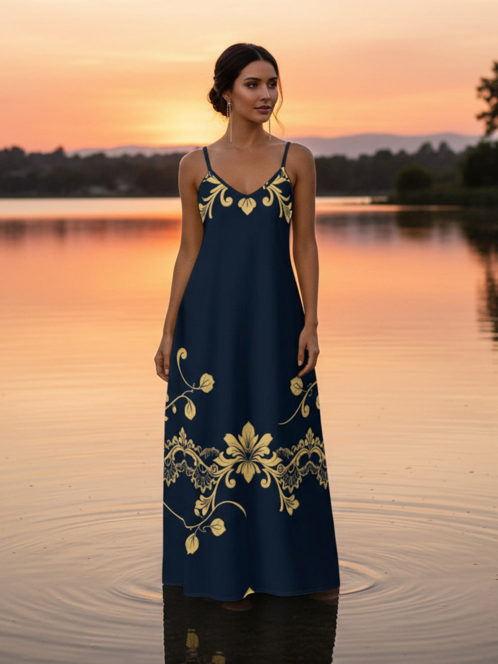 Women wearing royal blue maxi dress for women with gold floral design standing in water at sunset