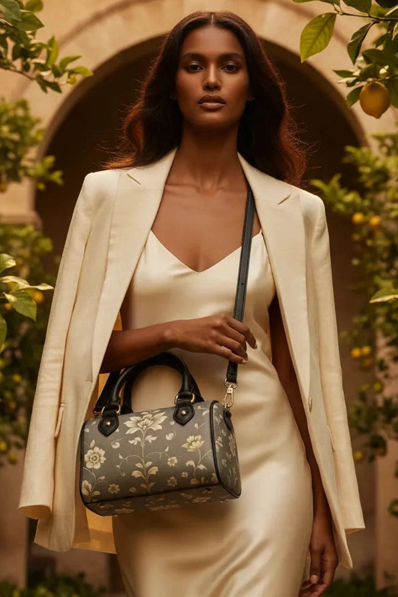 Angelic Blessings Shop silver floral baroque Crossbody satchel carried by woman in elegant cream dress and jacket